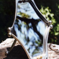 Mirror, 1990, aluminum motorcycle levers, acrylic. 12" x 7" x 8"